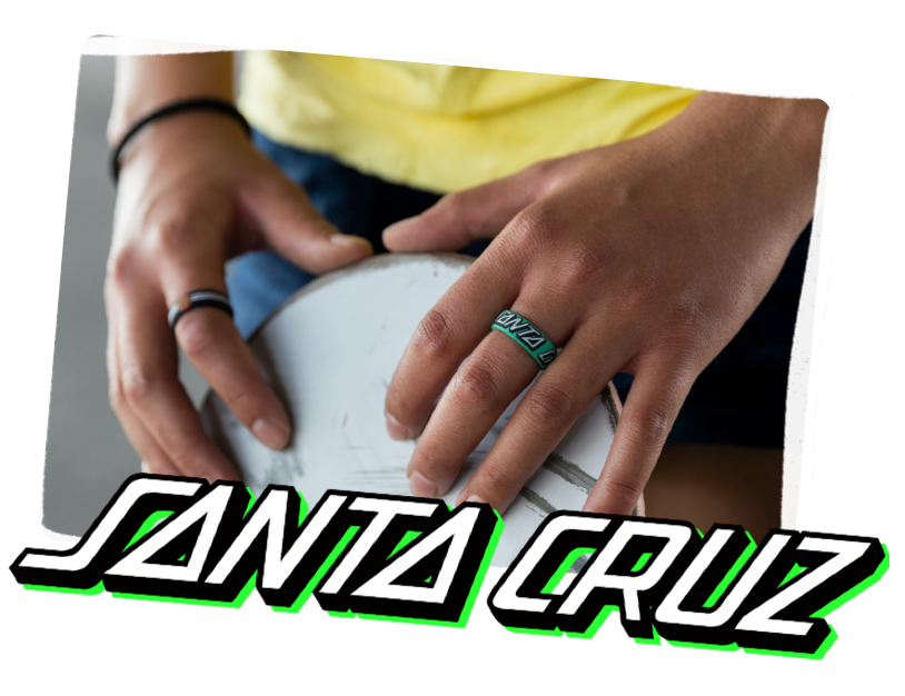 Hand holding skateboard with classic dot black ring