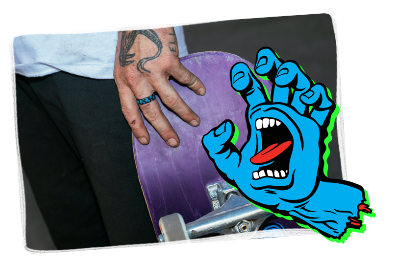 Hand holding skateboard with classic dot black ring