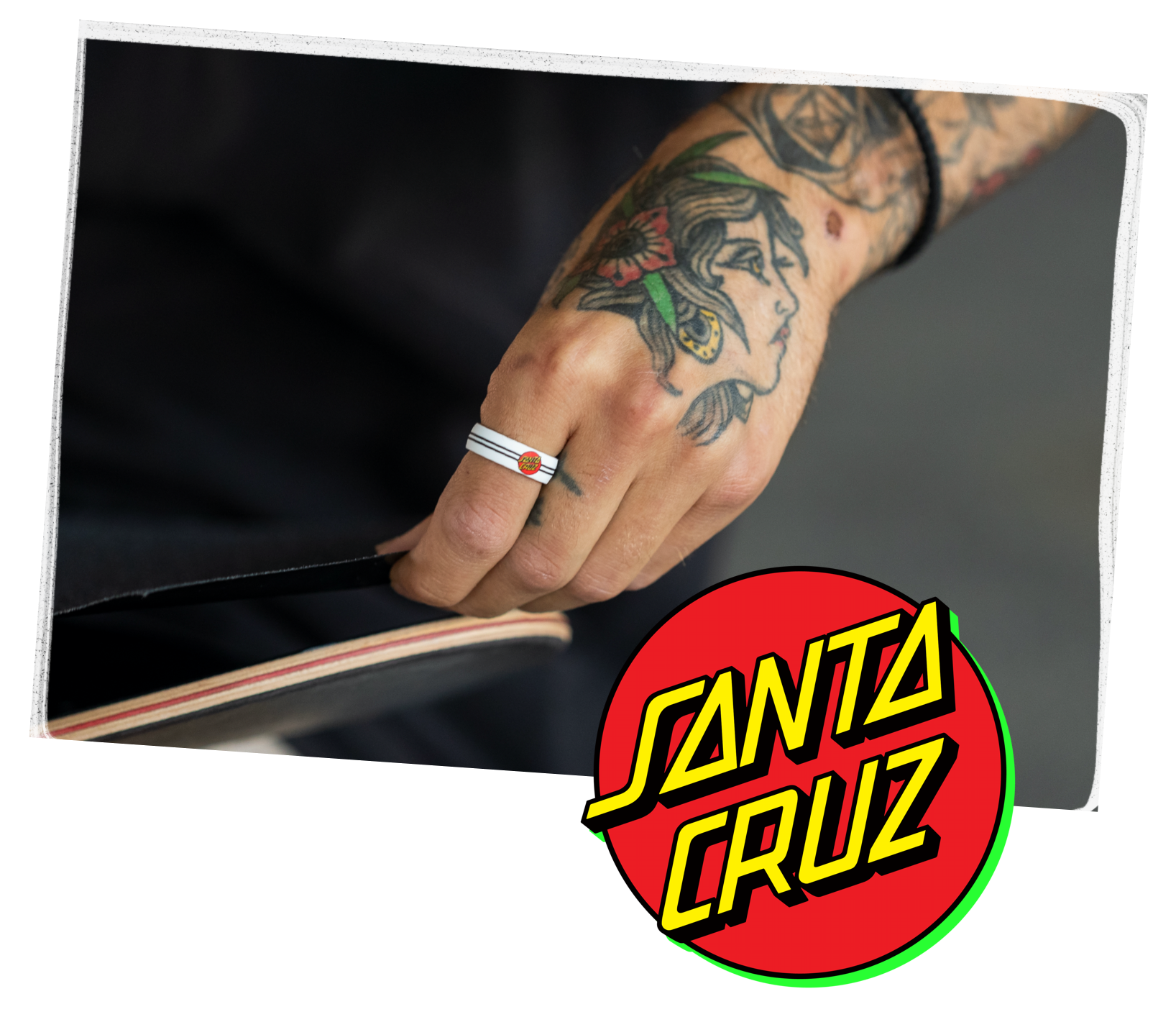 Hand holding skateboard with classic dot black ring