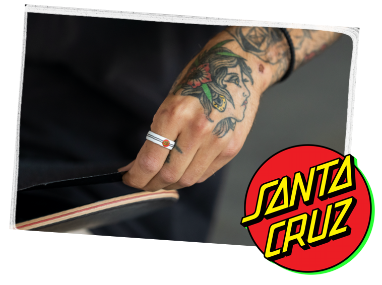 Hand holding skateboard with classic dot black ring
