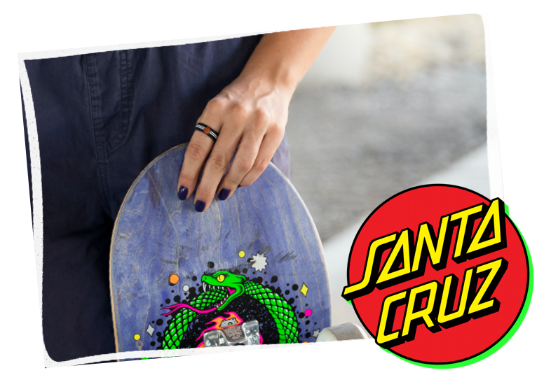 Hand holding skateboard with classic dot black ring