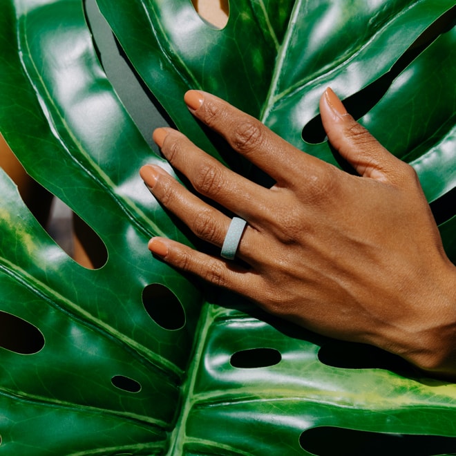 Beautiful dark complexion woman's hand sporting the new Enso Ring's Coral Apo Reef design