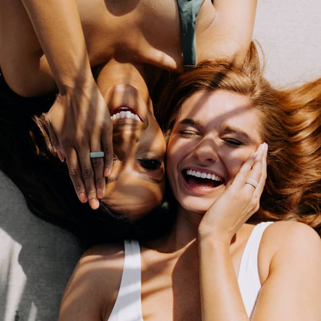 Beautiful girls laughing while wearing Enso's new Coral collection of rings